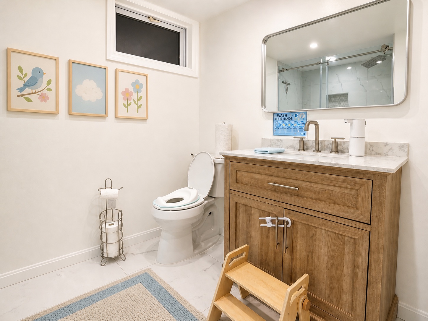 The clean, child-friendly Bluebird Learning Nest bathroom with a step stool, safety latch, sink, toilet, and handwashing guidance
